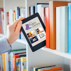 Academic places an e-book on library shelf in between traditional books 