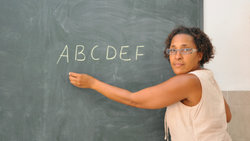 Woman writes on blackboard 