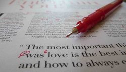 A fine line pen rests on the edited version of an author's article 