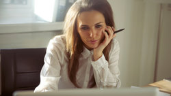 Woman looks intently at computer 