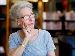 Pensive woman looks outside