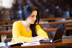 Female academic writes her thesis