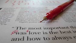 A fine line pen rests on the edited version of an author's article