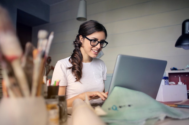 Cheerful female academic conducts research online